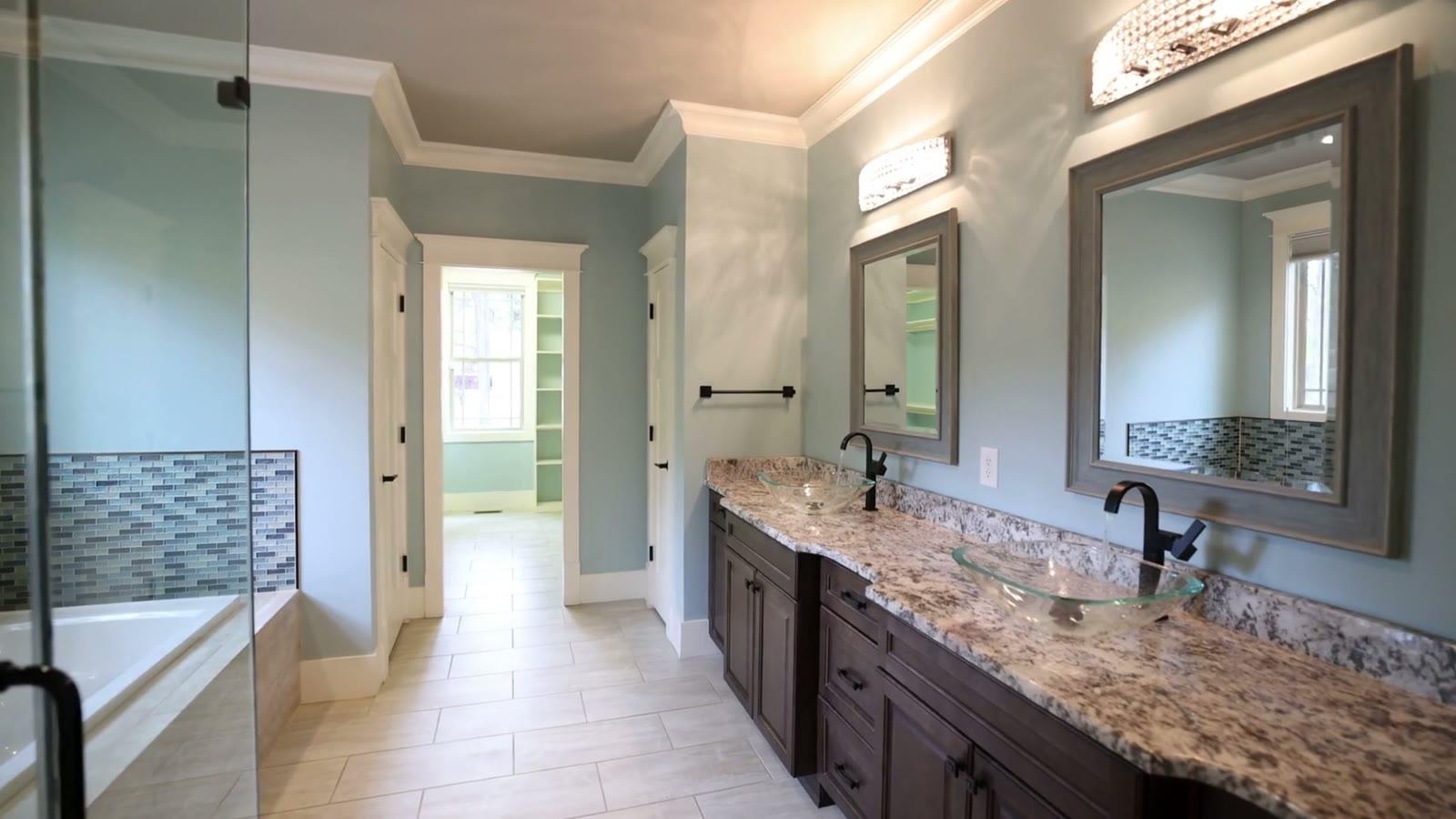Finished bathroom remodel: vanity run, framed mirror and tiled floor